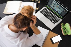 Stressed woman at a cluttered desk